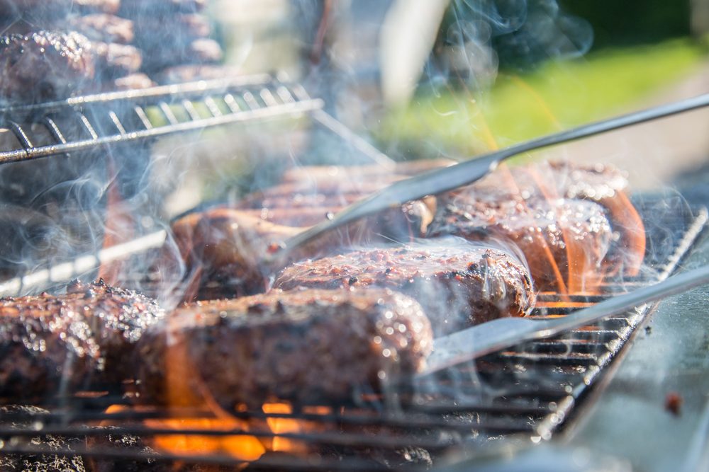 Patties on an open flame grill